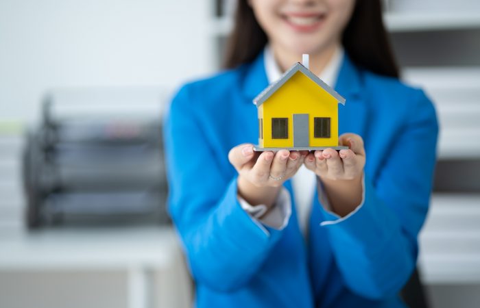 Real estate house agent showing house model to customer, real estate housing concept. Real estate house agent showing house model to customer, real estate housing concept.